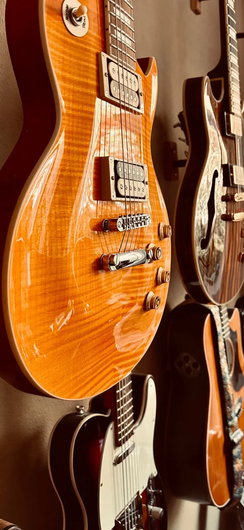 Close view of guitars hanging on the studio wall